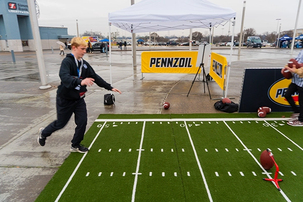 Fan Kicking Football At Activation